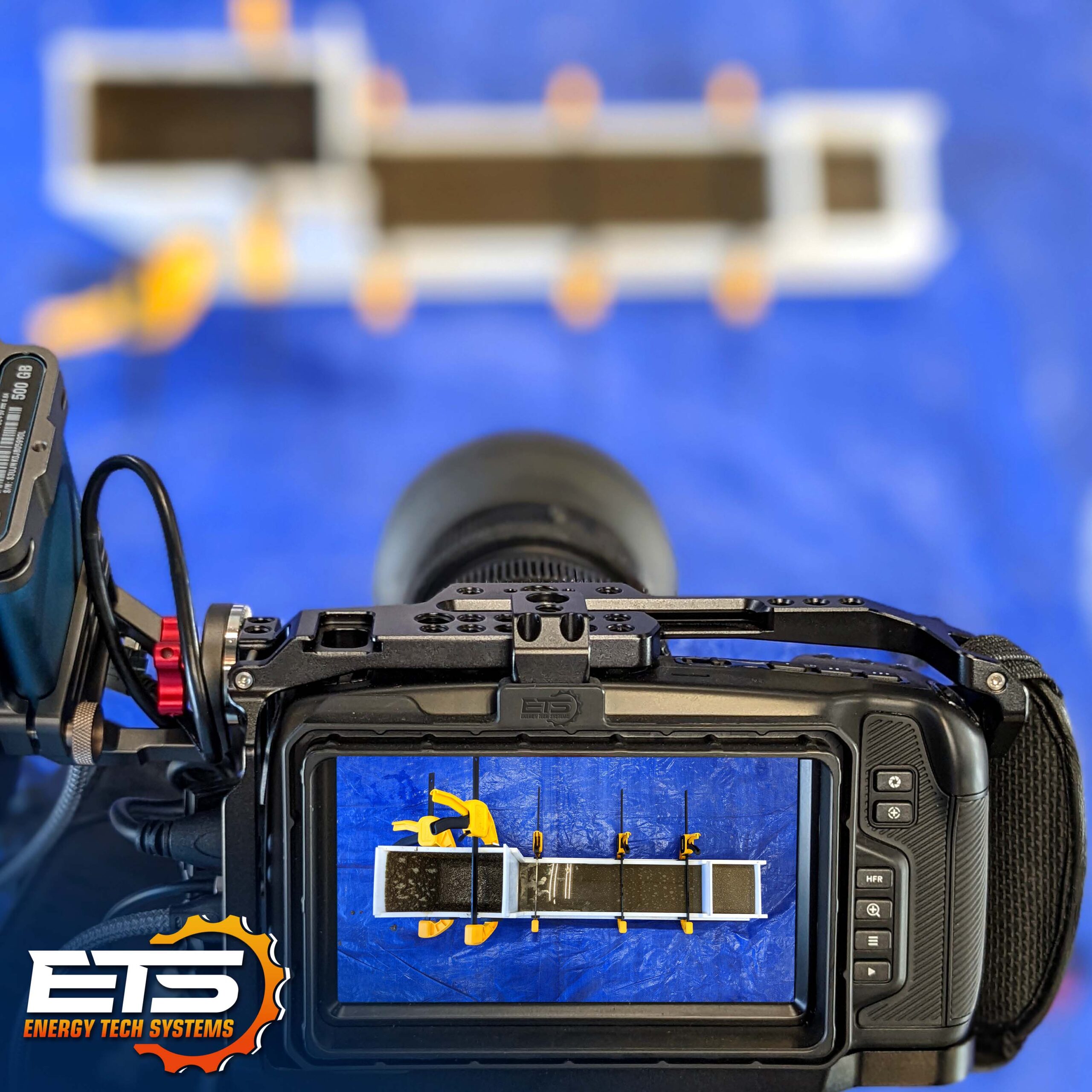 A camera filming the epoxy grout flow box test.