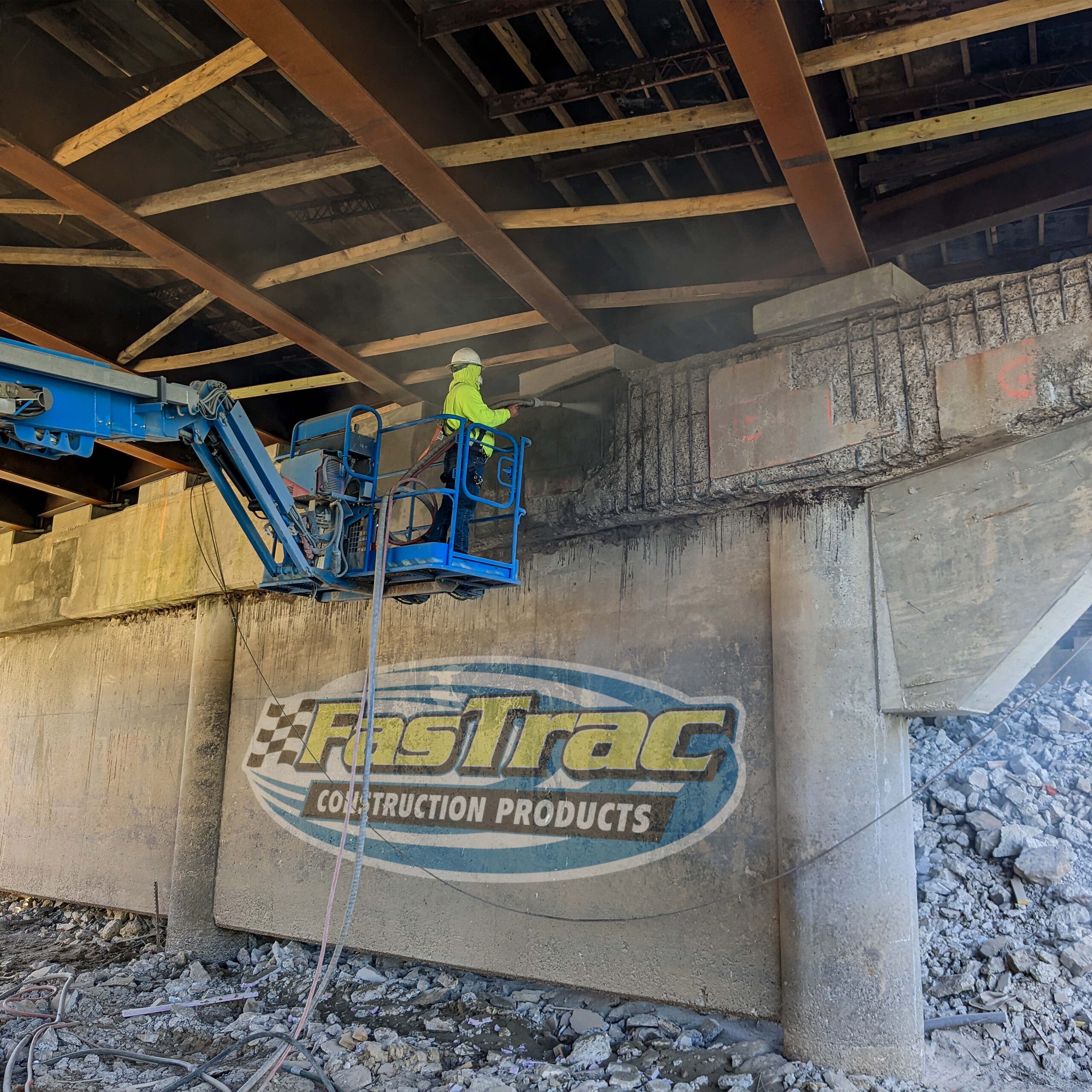 Construction worker spraying FasTrac Shotcrete under a bridge in Oklahoma