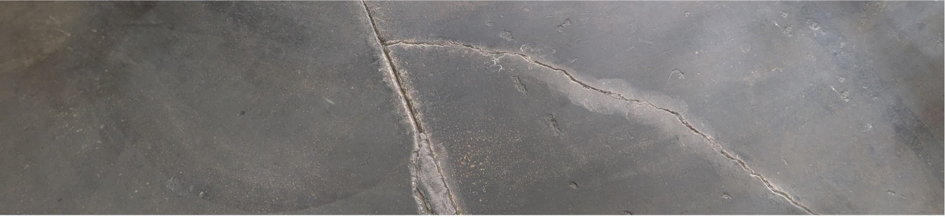 Photo of a cracked concrete warehouse floor in need of repair with FasTrac Crackweld Pro.