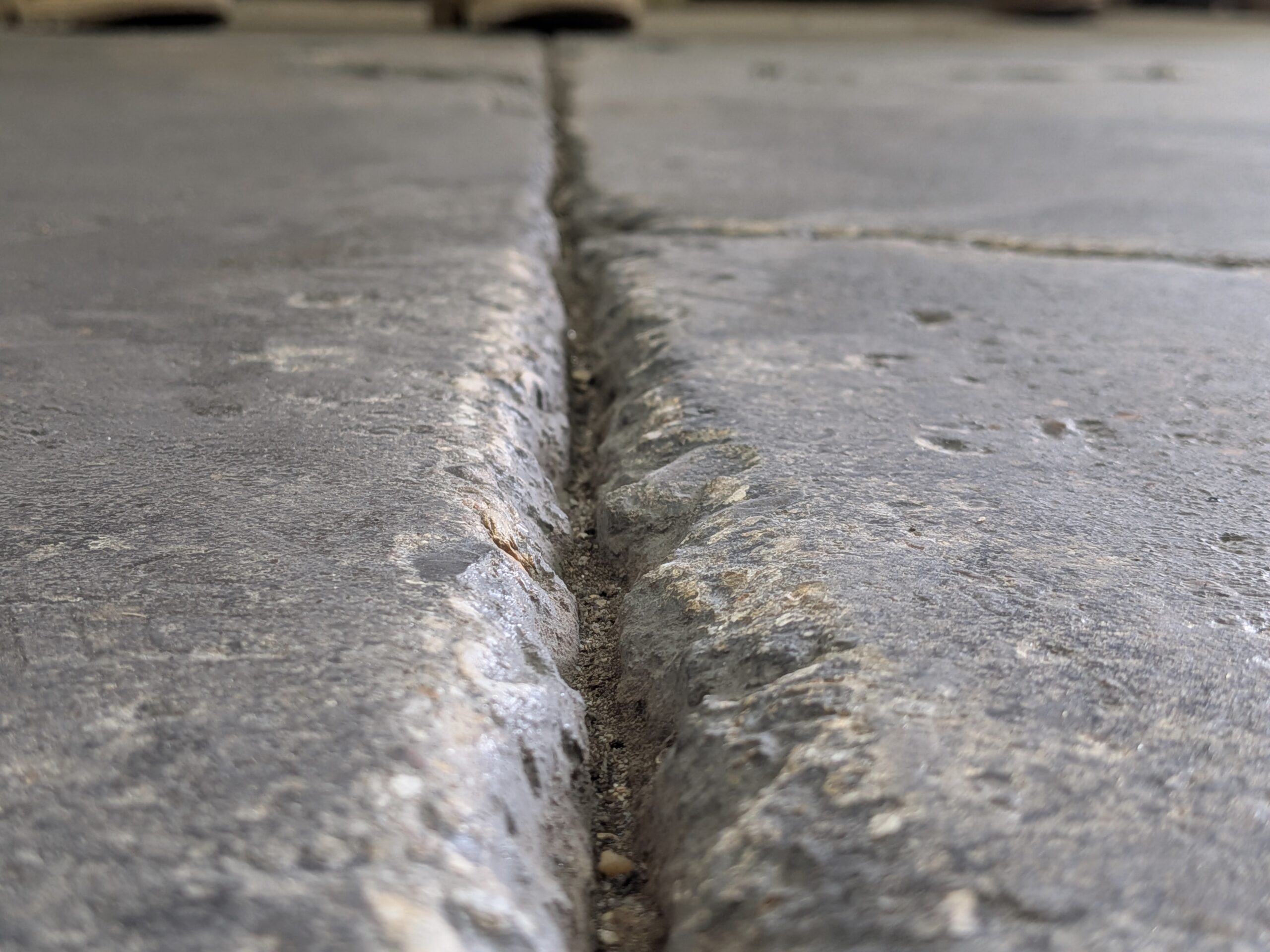 Photo demonstrating the depth of a concrete floor crack before being repaired with FasTrac Crackweld Pro.